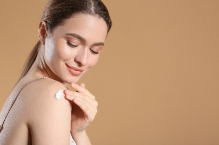 Image of woman applying cream to skin